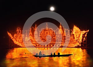 Raditional fire boat floating in Mekong river at night with design the light lamp about Phrathat Phanom Pagoda, king of Thailand