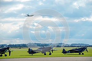 RAF fighter aircraft from the Battle of Britain era parked at an airfield