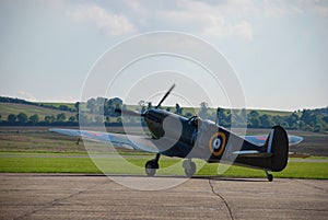 RAF fighter aircraft from the Battle of Britain era parked at an airfield