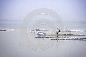 The raft floating fish farming and birds in Krasiew dam ,Supanburi Thailand