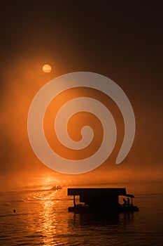 Raft house and boat with sunrise at Sangklaburi, Thailand