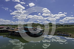 Raft house in lake with cloudy in Thailand