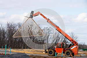 the rafters are lifted by a construction loader