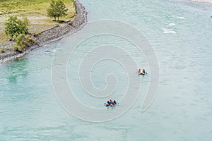 Rafters rafting down a mountain river