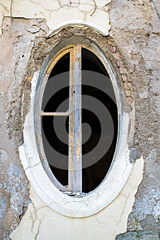 Ragged oval window in an old building