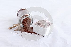 Ragi Flour in a Bowl and Ragi Spilled from a Bottle