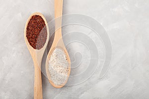 Ragi or Nachni, also known as finger millet and ragi coarse flour in wooden spoons on grey textured table. Top view, copy space
