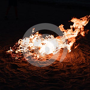 Raging fire on the beach at night