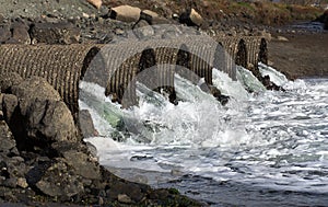 Raging Floodwater Drains Trhough Culvert Pipes