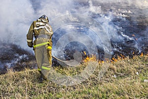 Raging forest spring fires. Burning dry grass, reed along lake. Grass is burning in meadow. Ecological catastrophy. Fire and smoke