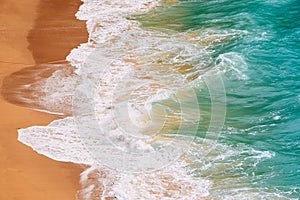 Raging ocean, azure coast with a golden sandy beach. Top view, drone view Benagil Beach in Portugal