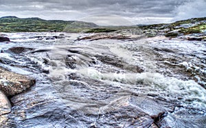 Raging river in the middle of Norwegian tundra