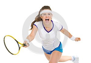 Raging tennis player hitting ball