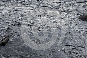 background of the force of the water in the blue-gray river