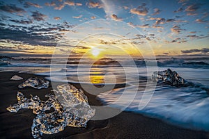 Raging waves smashing ice blocks at sunrise on Diamond Beach