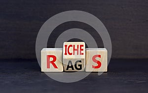 Rags or riches symbol. Concept word Rags Riches on wooden cubes. Beautiful black table black background. Business and rags or