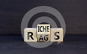 Rags or riches symbol. Concept word Rags Riches on wooden cubes. Beautiful black table black background. Business and rags or