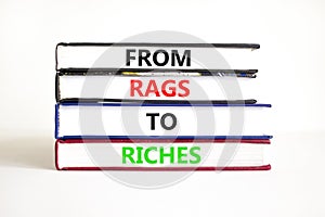 Rags or riches symbol. Concept words From rags to riches on books. Beautiful white table white background. Business rags or riches