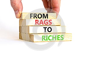 Rags or riches symbol. Concept words From rags to riches on wooden blocks. Beautiful white table white background. Businessman