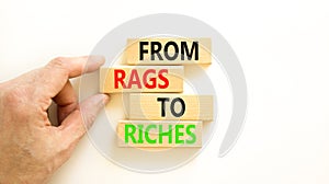 Rags or riches symbol. Concept words From rags to riches on wooden blocks. Beautiful white table white background. Businessman