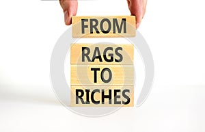 Rags or riches symbol. Concept words From rags to riches on wooden blocks. Beautiful white table white background. Businessman