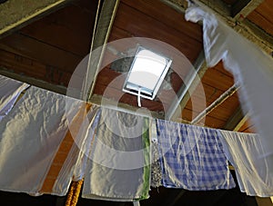 rags and tea towels hung out to dry after washing in the attic o