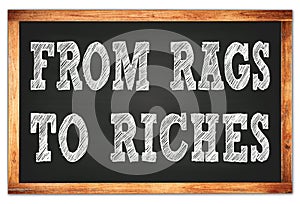 FROM RAGS TO RICHES words on black wooden frame school blackboard