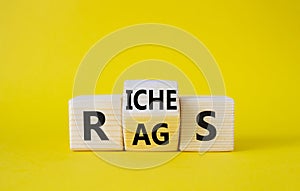 Rags vs Riches symbol. Wooden cubes with words Rags and Riches. Beautiful yellow background. Rags vs Riches and business concept.