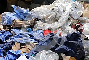 Rags and waste fabrics in the landfill photo