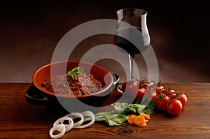Ragu in bowl and red wine photo