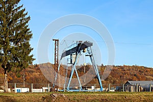 Rail crane in production. Loading and unloading wagons. Lifting heavy loads. Metal structures for payload. View of an industrial e