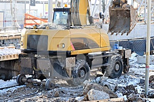 Rail excavator. Excavators machine excavate on railway. Construction of the underpass under the railway in winter. Russia