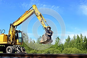 Rail excavator working with rubble.