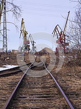 Rail road tracks under the gantry cranes on the berth of sea merchant port