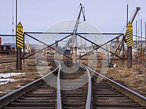 Rail road tracks under the gantry cranes on the berth of sea merchant port