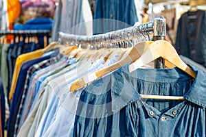 Rail of second-hand clothes on display photo