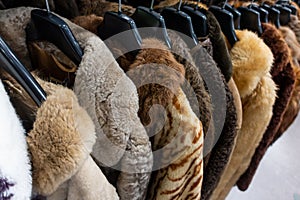 Rail of Secondhand Fur Coats For Sale in a Thrift Store Shop