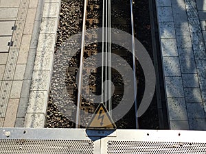 Rail tracks with high voltage warning sign