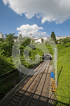 Rail tracks leading to a tunnel as seen from a bridge in France