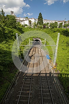 Rail tracks leading to a tunnel as seen from a bridge in France