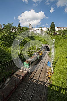 Rail tracks leading to a tunnel as seen from a bridge in France