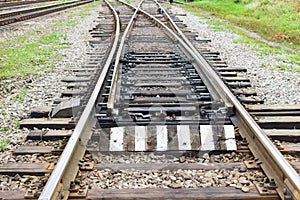 Rail tracks with rail sleepers at the railway pointwork. Change of direction. Railway arrows with rail track elements