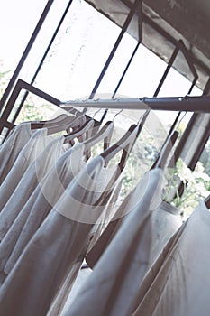 Rail with white t-shirts on hangers in the store