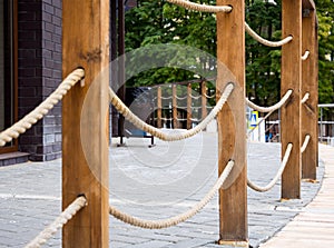 Railing in the form of wooden posts with tensioned ropes