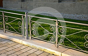 railing historical park black iron cast metal low paving lawn grass green beige