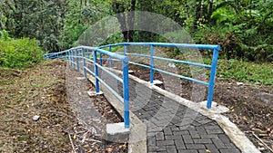 Railing pavingblock pathway to waterfall