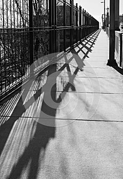 Railing shadow on the bridge. Bridge railing casts a shadow. Abstract bridge railing shadow