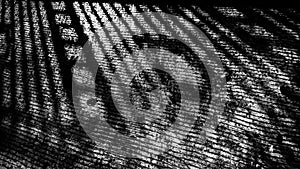 A railing shadow on the cement floor