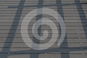 Railing shadow on wooden planks