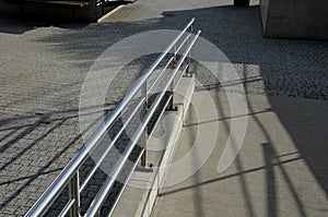 Railing with two handrails. made of galvanized steel prisms. the lower railing is a protection against wheelchairs. ramp for the i